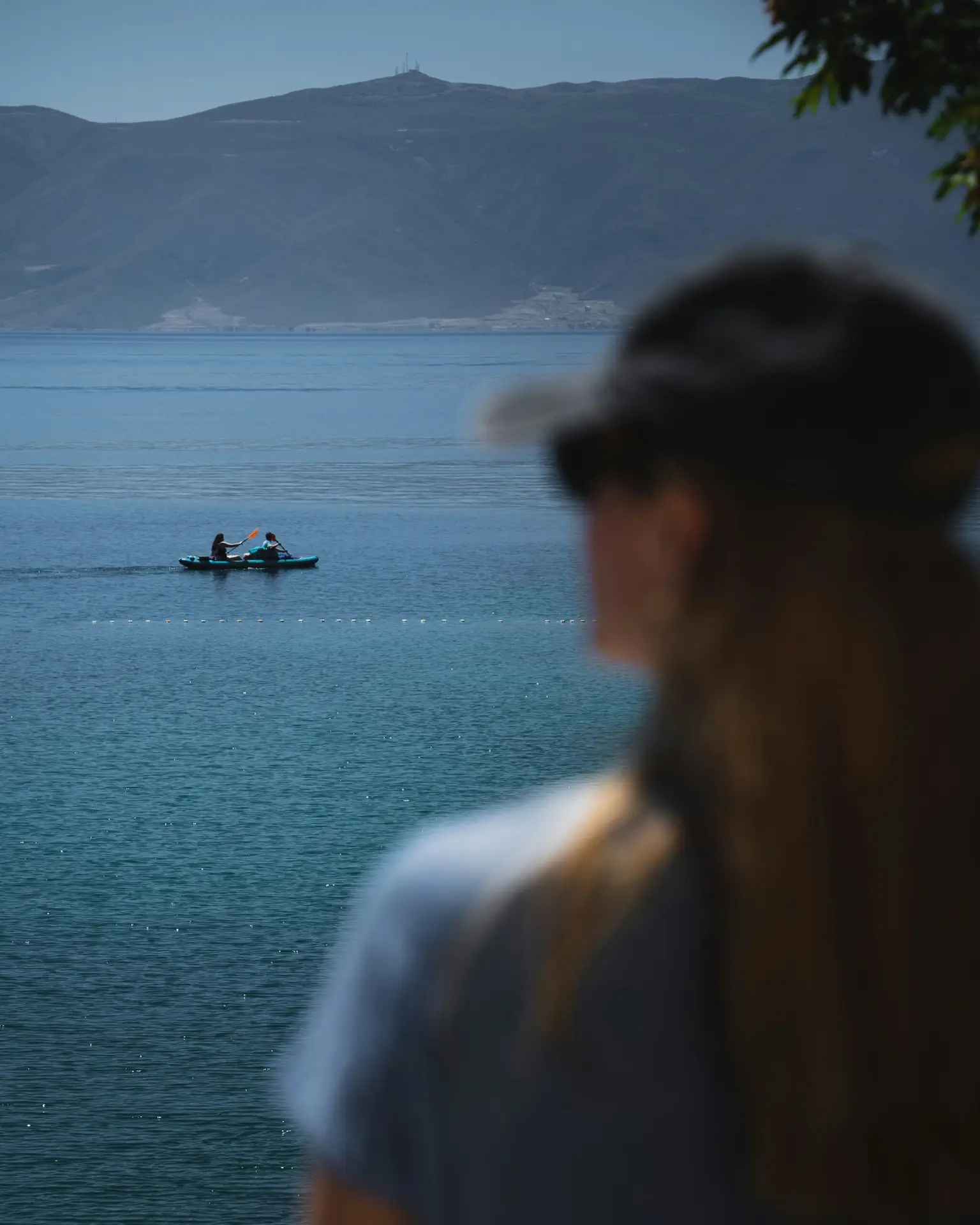 man and woman standing near body of water during daytime